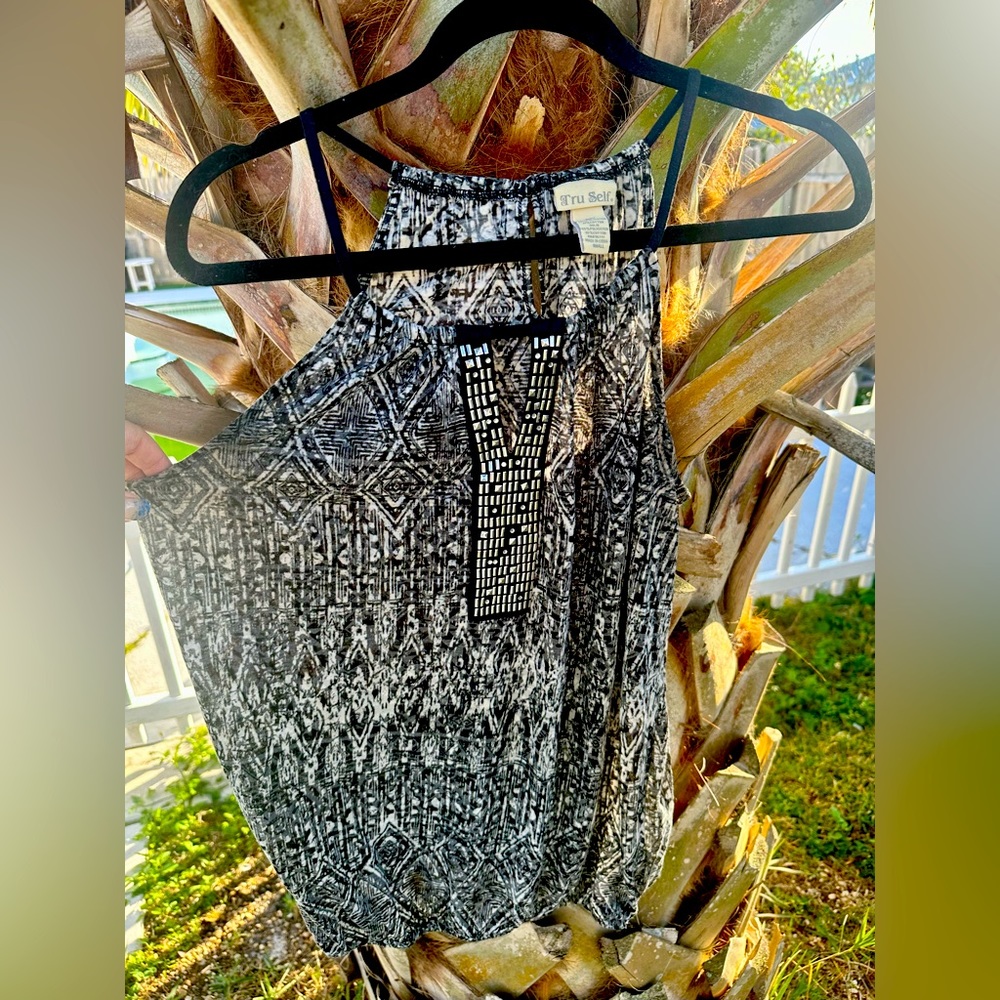 Comfortable keyhole blouse with metal embellishments.